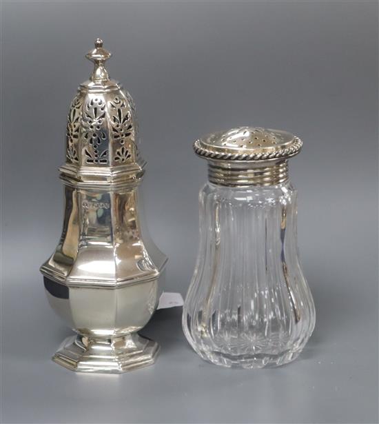 A late Victorian silver octagonal, London, 1890 caster and a German sterling mounted glass sugar caster, tallest 17.4cm,.